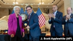 House Speaker Mike Johnson, R-La., center, presents the Congressional Gold Medal to Ann Hammond, daughter of NASA's Dorothy Vaughan, in Washington, Wednesday, September 18, 2024.